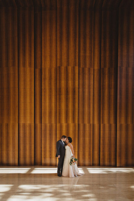 Bride and groom share a kiss during wedding portrait session at the Bridge Building, a downtown Nashville wedding venue