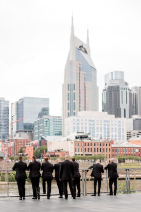 Groomsmen Looking Out at Downtown Nashville on Riverfront Patio