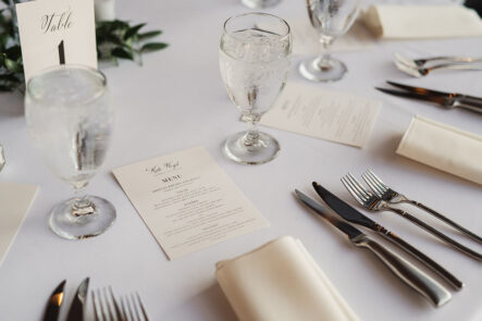 Classic romantic wedding table setting with custom printed menu cards and ivory napkins at The Bridge Building, downtown Nashville wedding venue