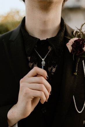 Closeup up of Chance Holding Black Crystal Necklace
