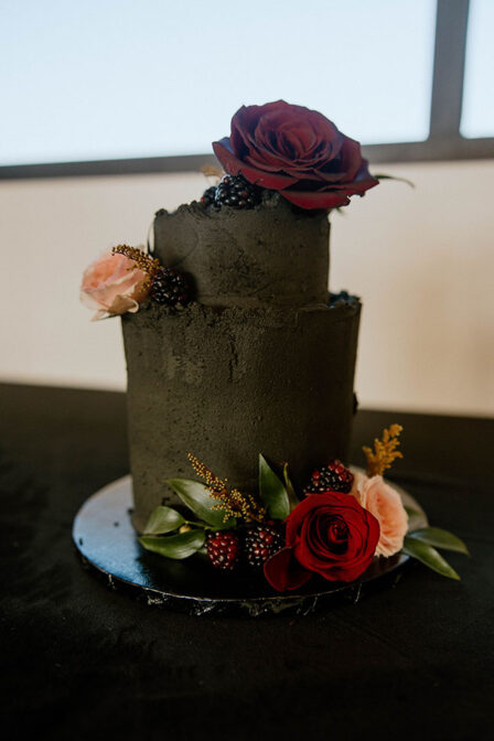 All Black Wedding Cake with Black Berries and Red Roses