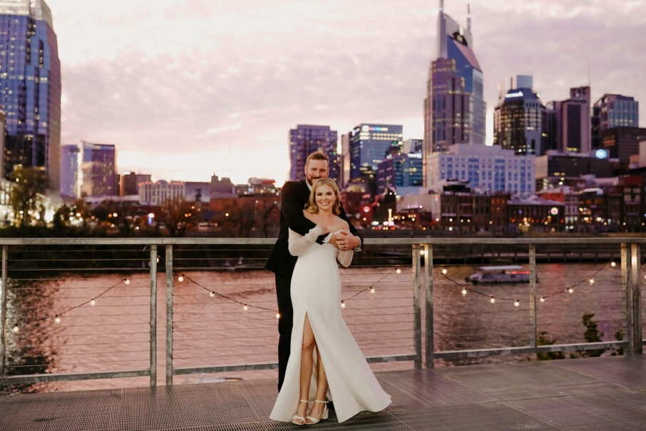 Haley and Andrew on the riverfront with downtown Nashville