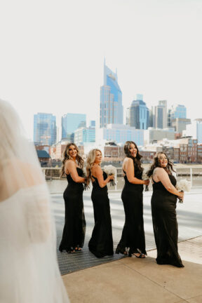 Haley's First Look with bridesmaids on Riverfront Patio