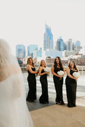 Haley's First Look with bridesmaids on Riverfront Patio