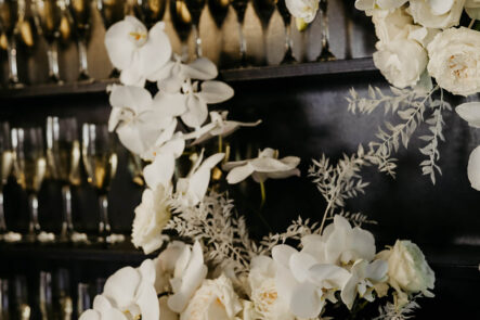 White Floral Arrangement on Champagne Wall