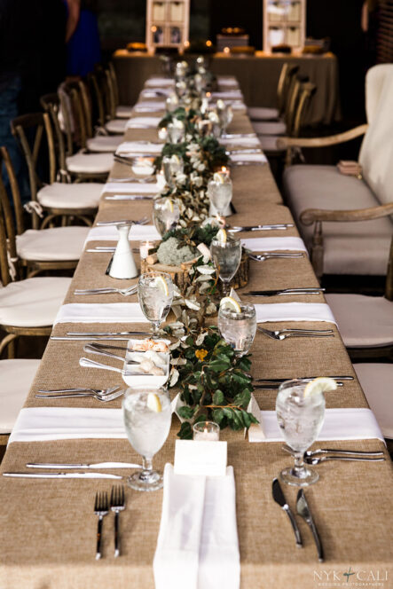 Farmhouse head table with burlap linens and dried greenery runner for nautical themed rehearsal dinner