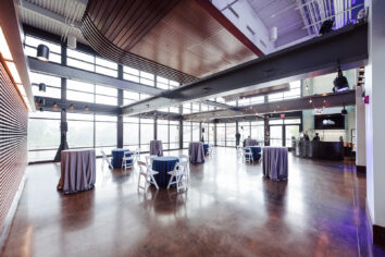 The Cumberand space with mixed bistro and cocktail tables with blue and gray linens