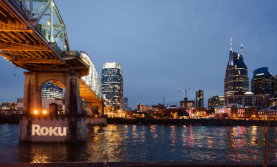 Roku's corporate logo projected onto the pedestrian bridge for corporate event in downtown Nashville