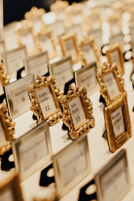 Escort cards in mini ornate gold picture frames for wedding reception at the Bridge Building, a downtown Nashville wedding venue