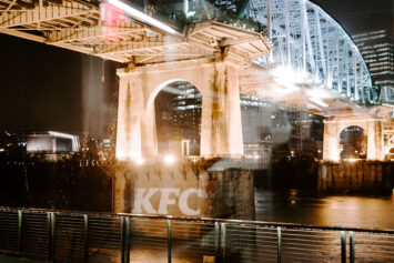 KFC logo projected onto the pedestrian bridge in downtown Nashville